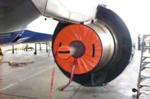 Engine inlet FOD protective cover installed on aircraft turbine engine for maintenance safety.