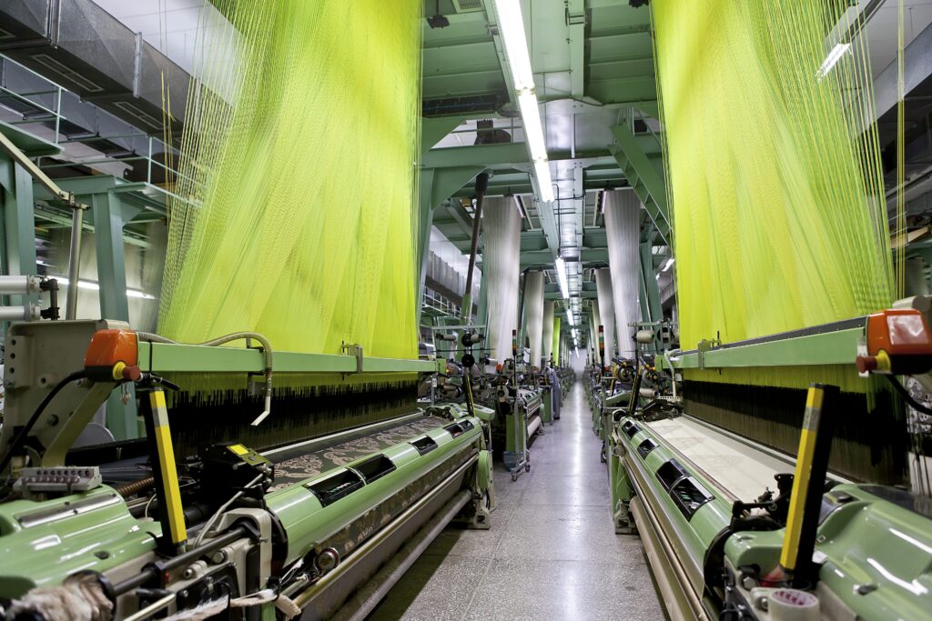 High-volume industrial weaving looms producing high-tenacity technical fabrics at Ehmke Manufacturing.