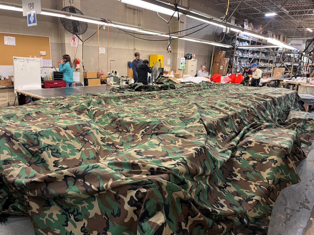 Industrial sewing machine to assemble military textile gear.